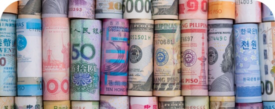 Rolled banknotes from various world currencies