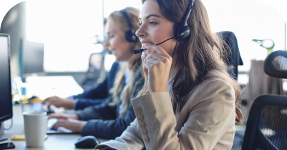 Call center agents wearing headsets at their desks