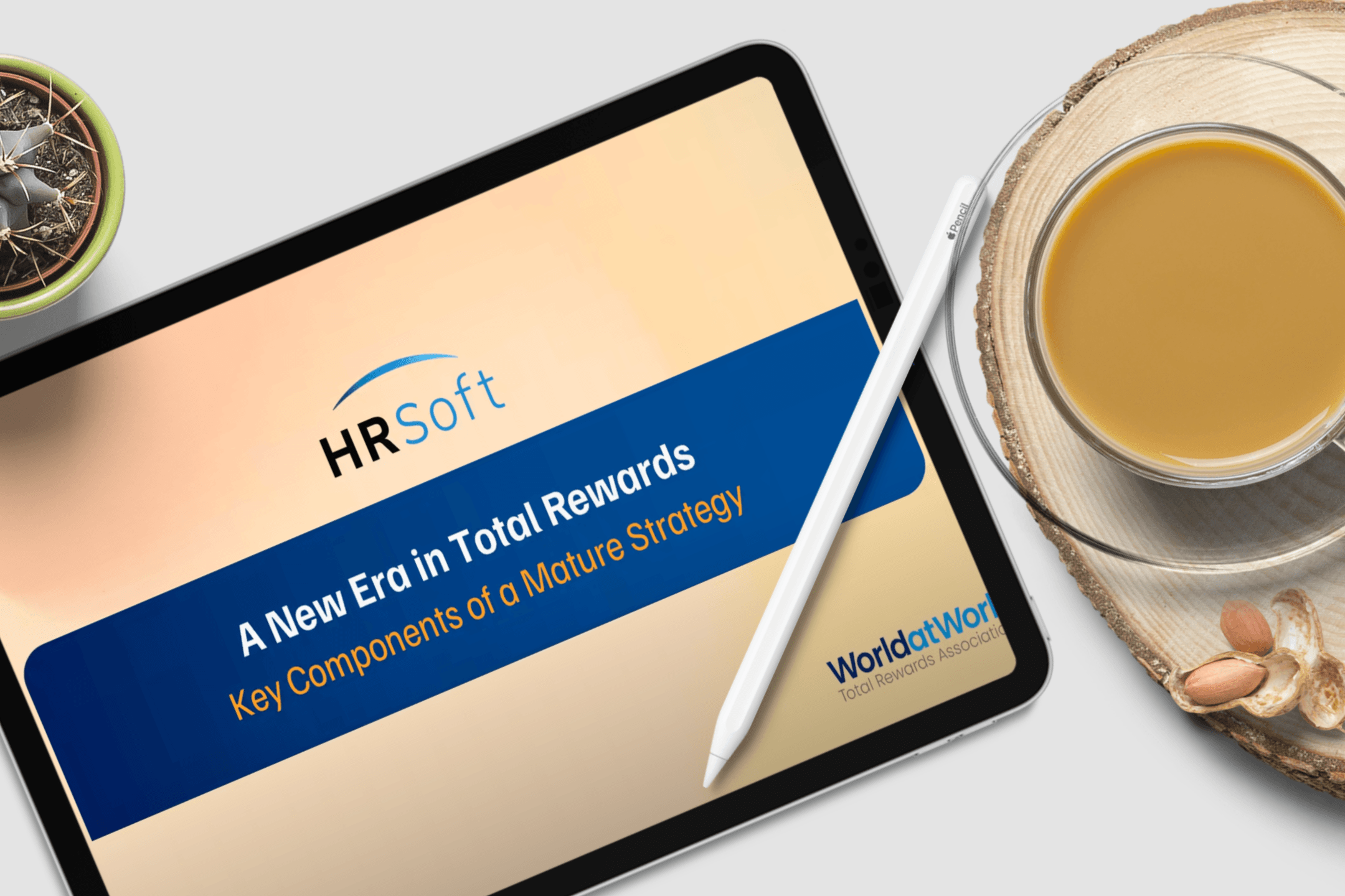 Tablet displaying an HRSoft 'A New Era in Total Rewards' presentation on a desk