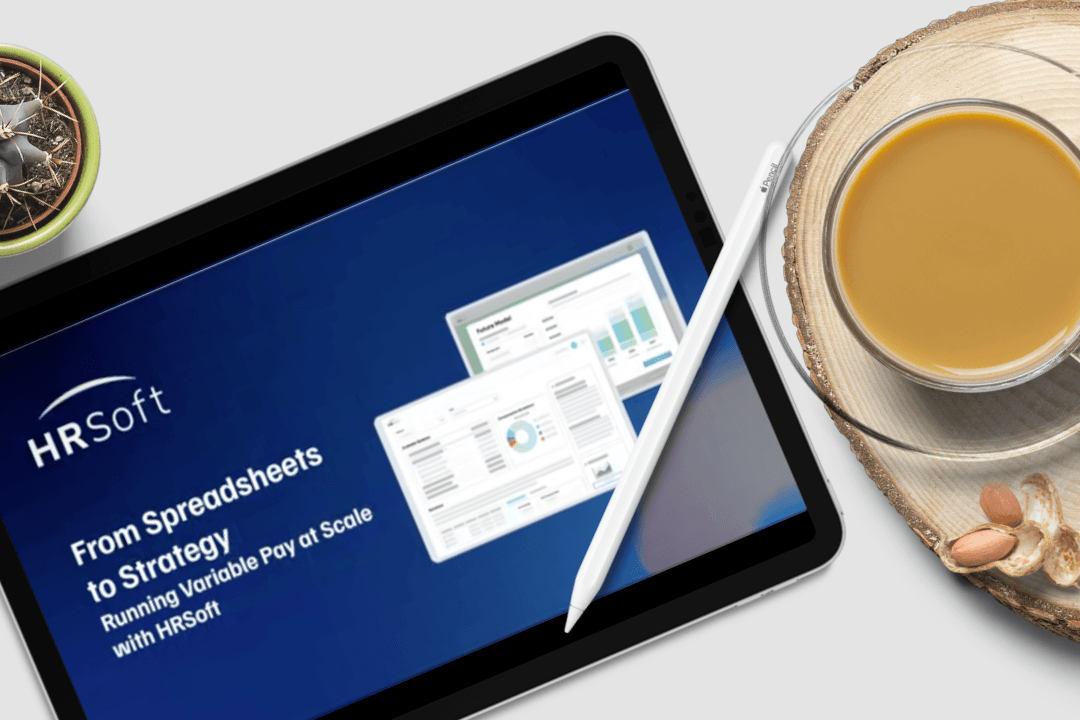 Tablet displaying an HRSoft 'From Spreadsheets to Strategy' presentation on a desk
