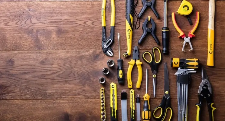 Collection of tools hanging on a wooden wall