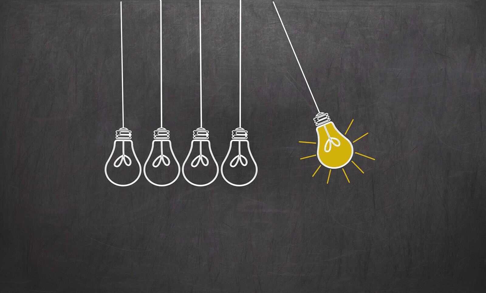 Creativity concept with light bulbs on chalkboard background