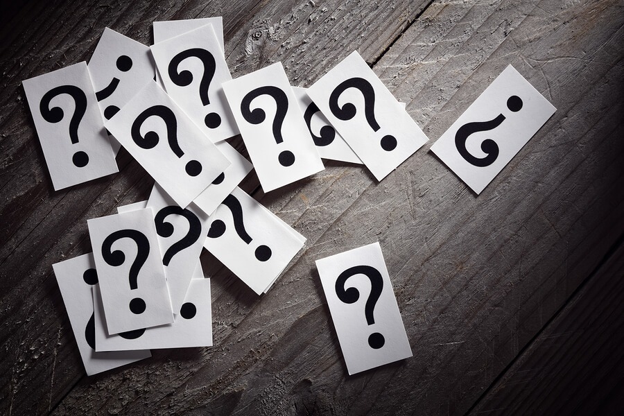 Question mark heap on table concept for confusion