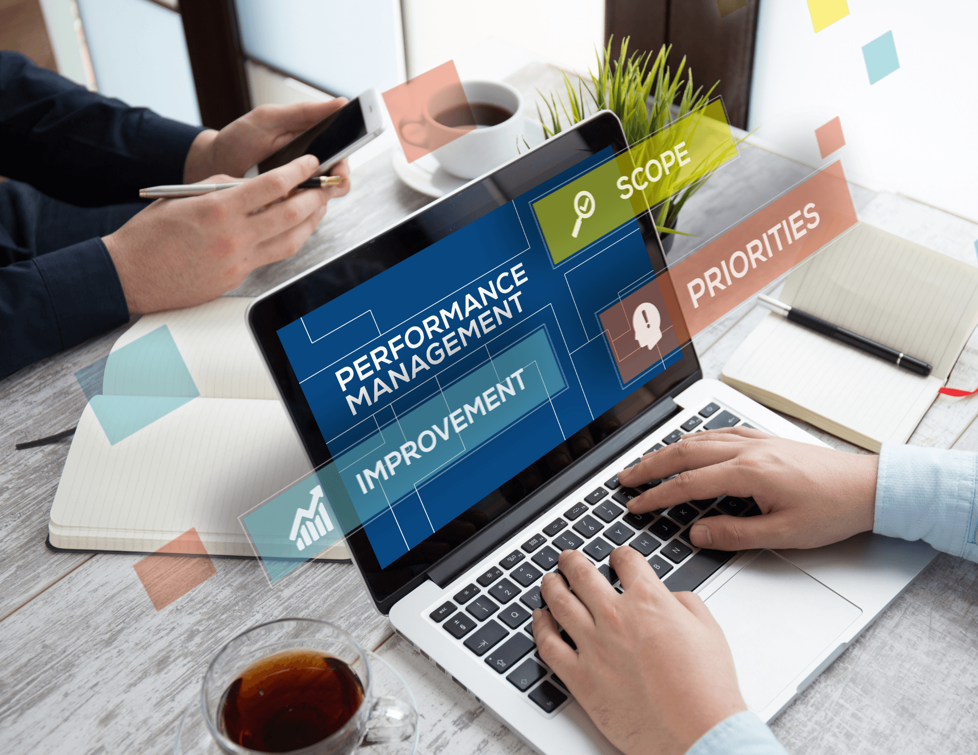 Hands on a laptop displaying a performance management screen