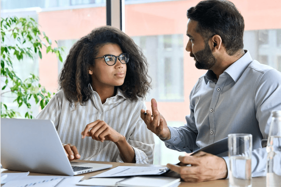 Two colleagues discussing at a laptop