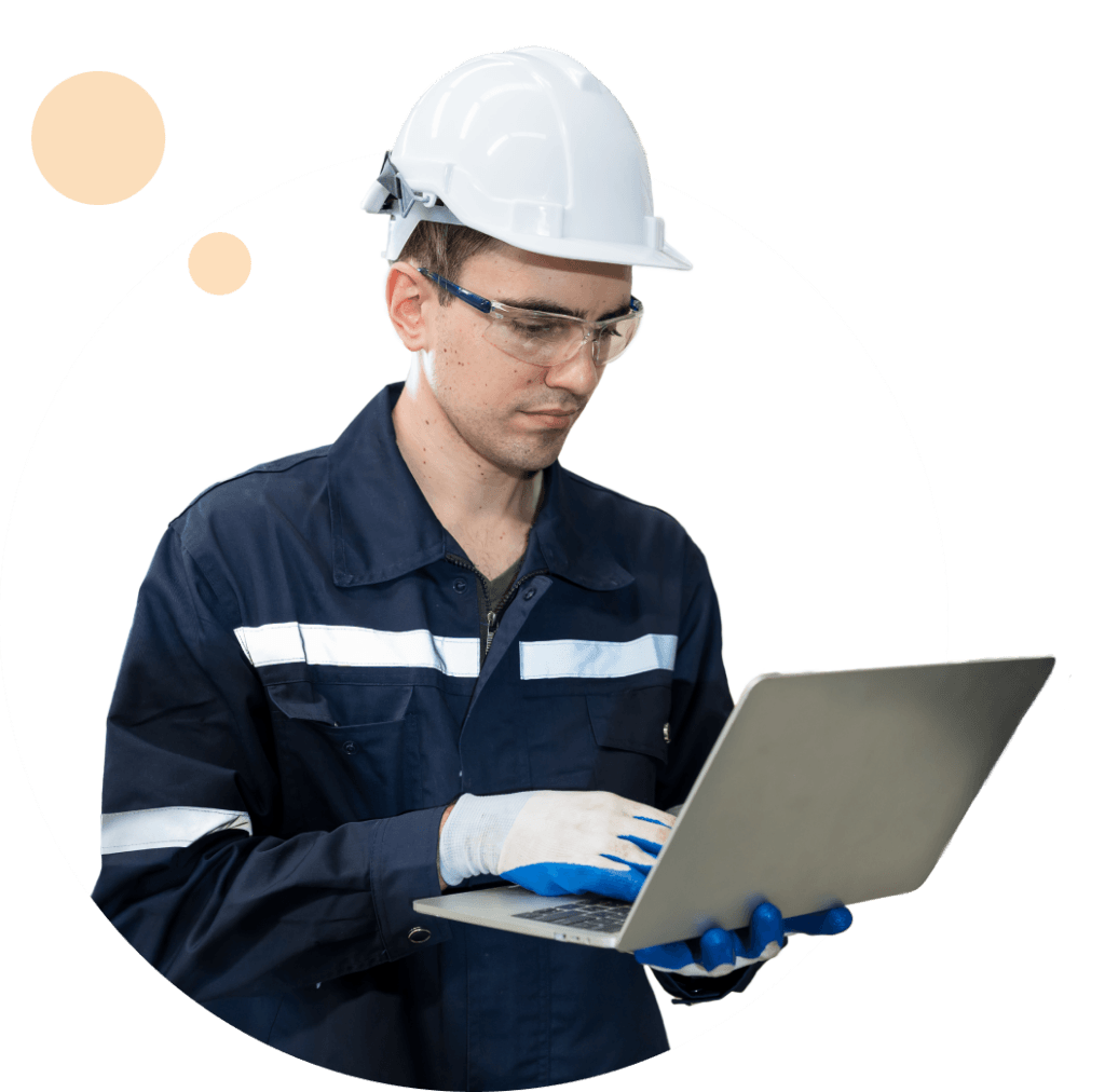Manufacturing worker in a hard hat using a laptop
