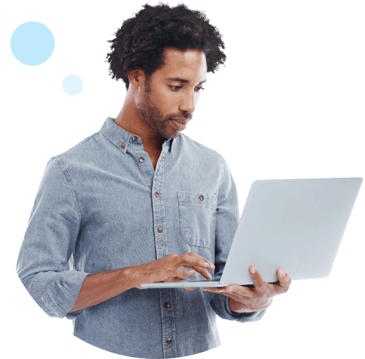 Man in a denim shirt using a laptop