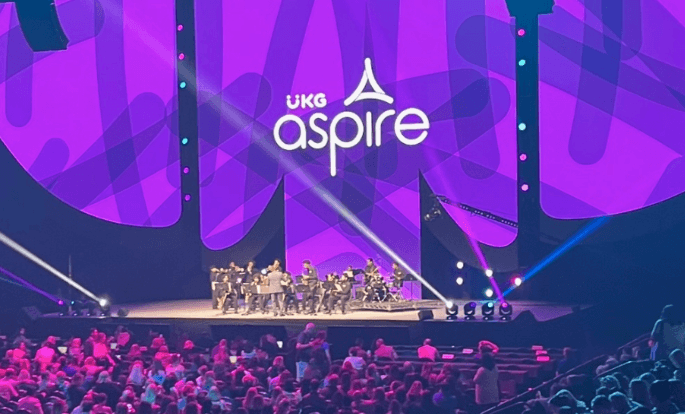 Stage at the UKG Aspire conference with an audience