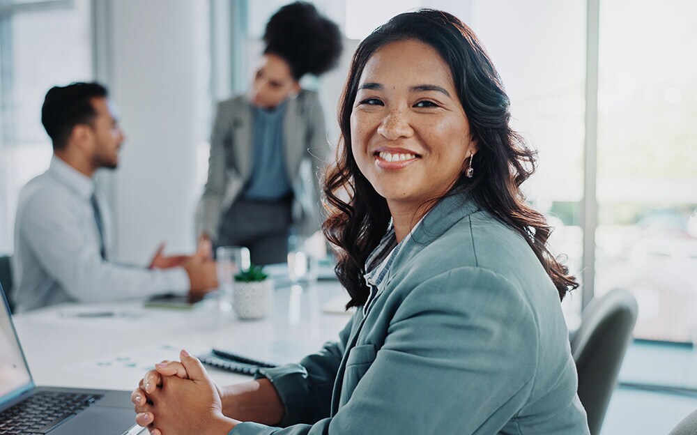 Smiling businesswoman in a meeting with colleagues