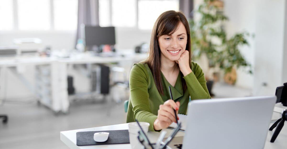 HR professional reviewing total rewards information on a laptop, illustrating the integration of compensation, benefits, and employee rewards in a modern workplace.