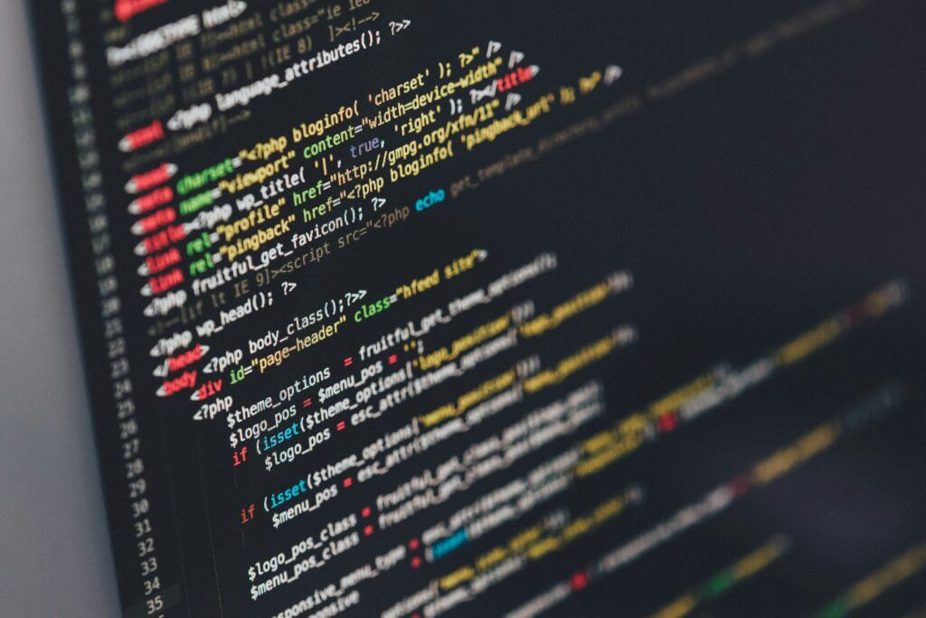 Close-up of colorful programming code on a dark computer screen
