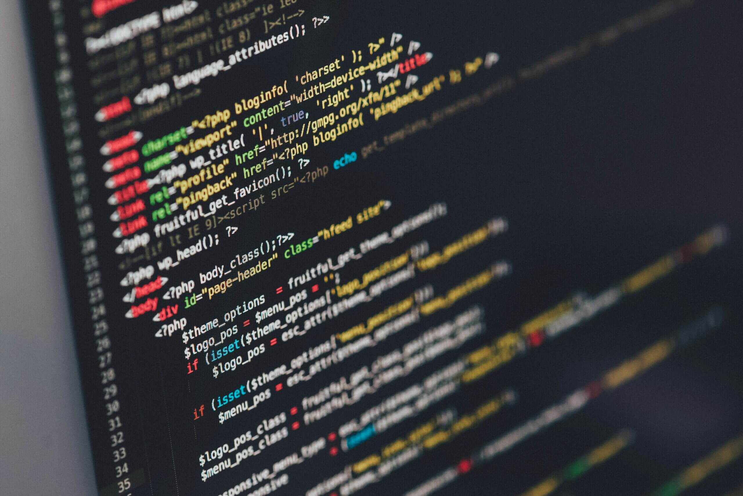 Close-up of colorful programming code on a dark computer screen