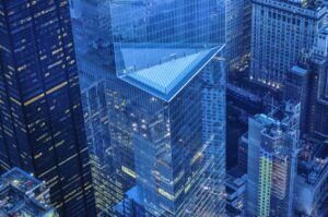 Aerial view of modern city skyscrapers with a glass pyramid-topped tower