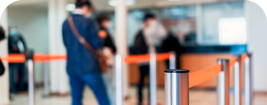 Travelers at an airport queue with luggage