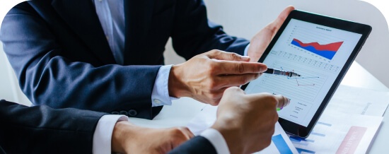 Person showing a tablet with charts to a colleague