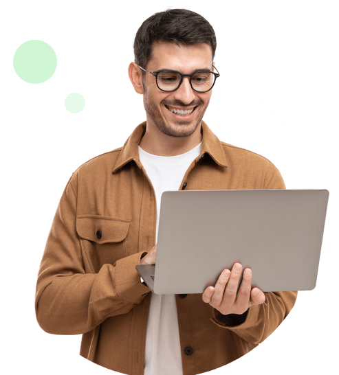 Man in a brown jacket holding a laptop