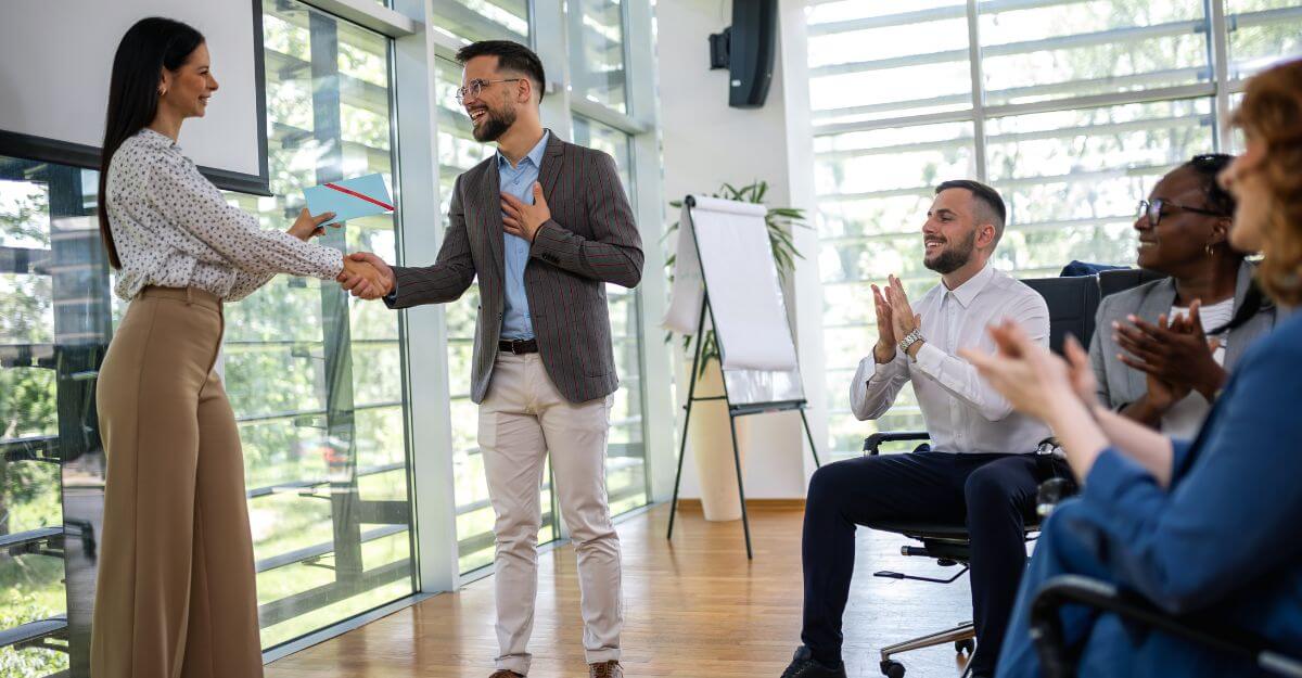 Boss hands employee envelope, conveying pay-for-performance