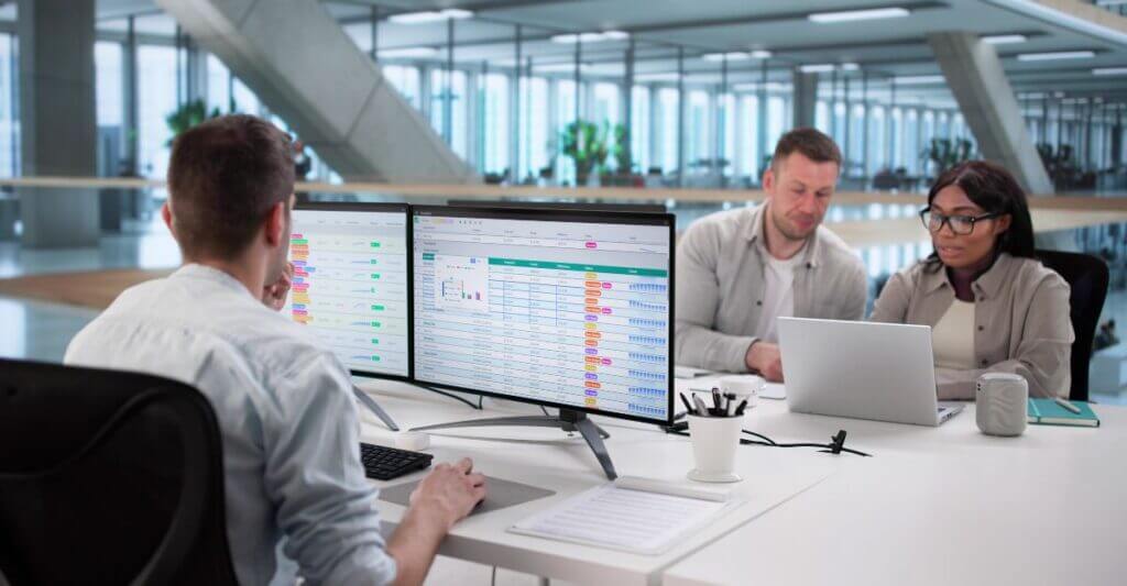 Team reviewing compensation data in a modern office, illustrating enterprise compensation management.