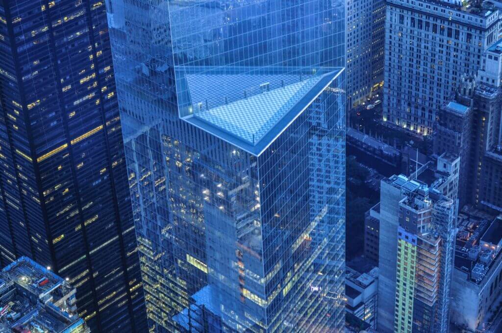 Aerial view of modern city skyscrapers with a glass pyramid-topped tower